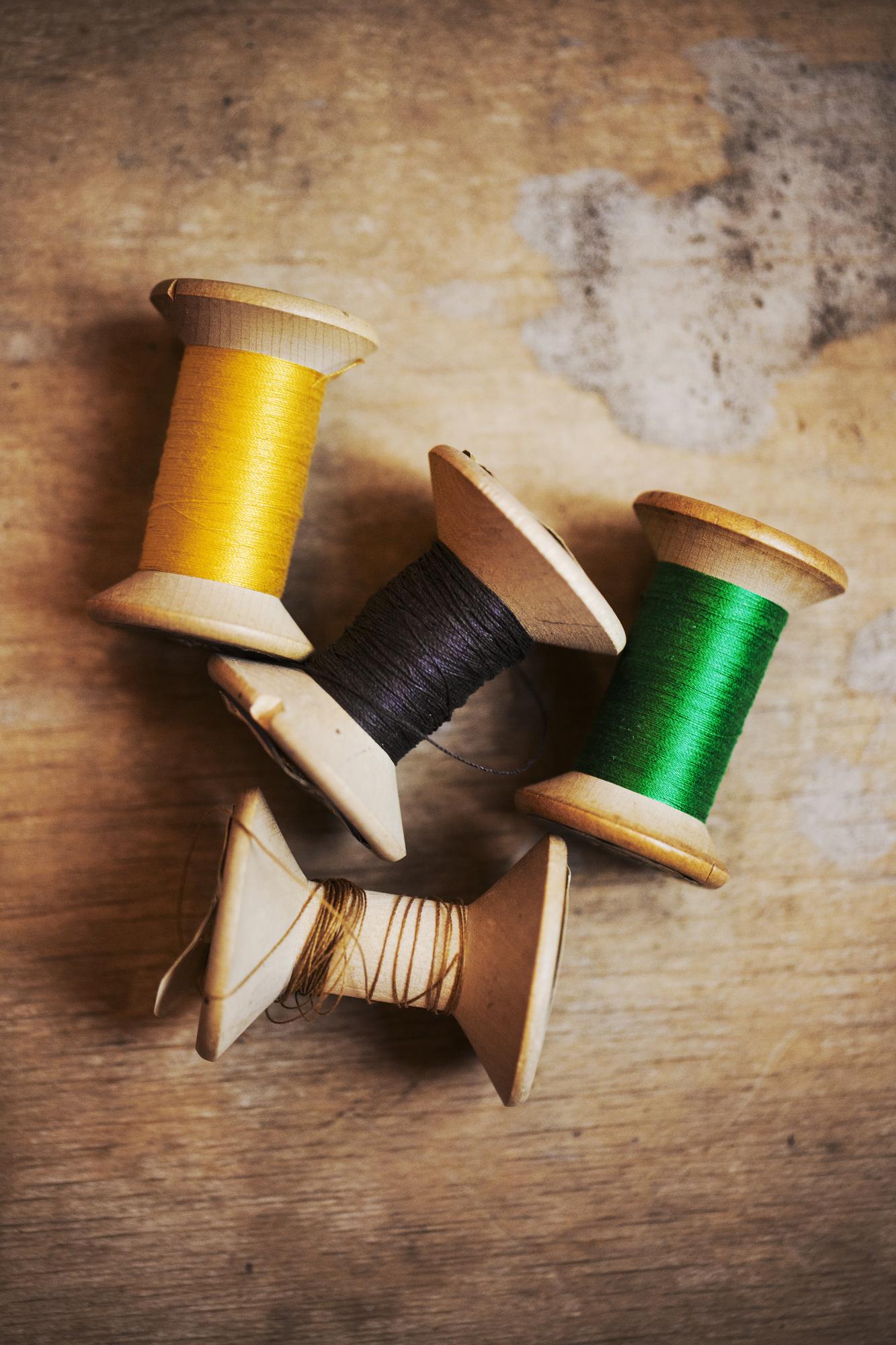 Stack of spools and embroidery threads on a table